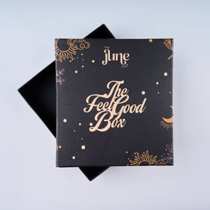 Black box with 'The Feel Good Box' text and decorative patterns on a light blue background